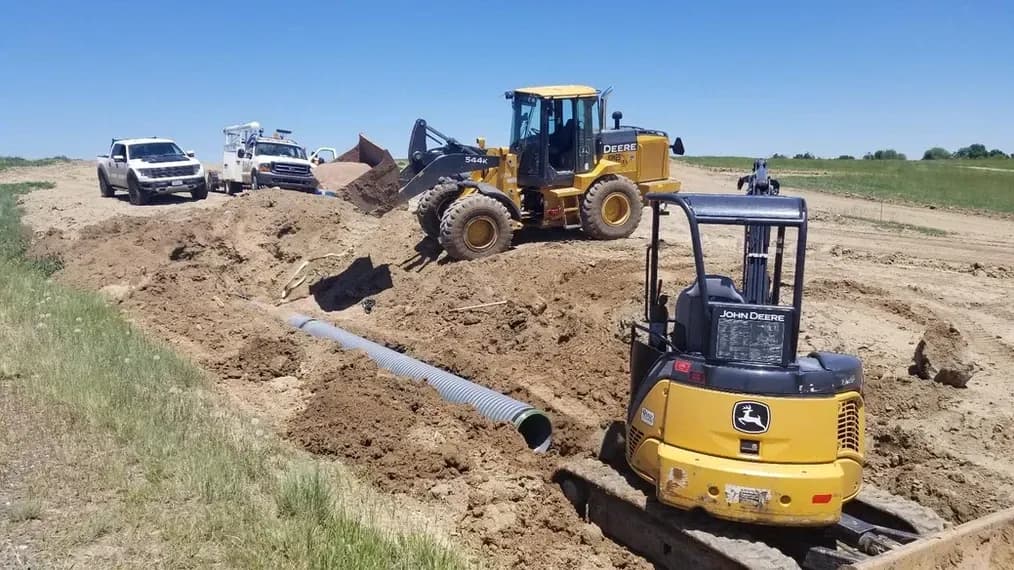 Construction vehicles working on a dirt road