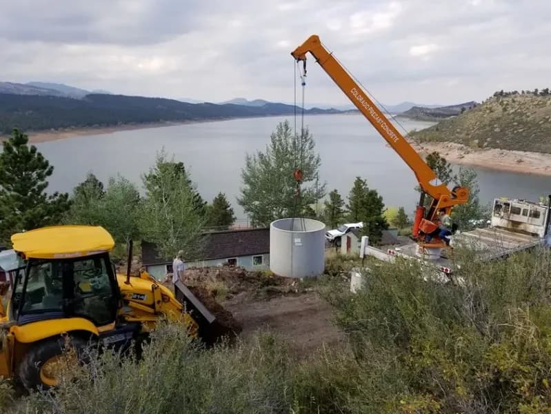 Crane lifting a concrete cylinder