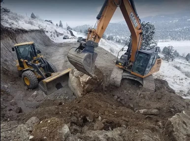 Two excavators digging a large trench